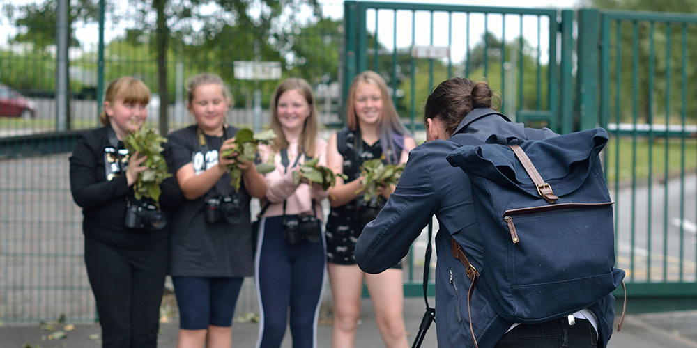 A group of young people posing for a photograph during a youth photography workshop